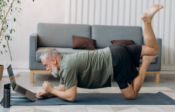 older man on yoga mat